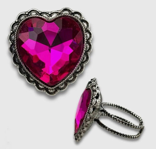 Make a bold move with our Wild At Heart ring y’all! Featuring a dazzling heart shaped stone framed in antique style silver detailing. This ring brings the perfect mix of western charm and glam edge. The oversized sparkle catches the light from every angle making it a true statement piece. Finished with an adjustable band for an easy comfortable fit this ring is made for the girls who wear their heart and their style out loud. Available in fuchsia or iridescent. 
Made in the USA

 