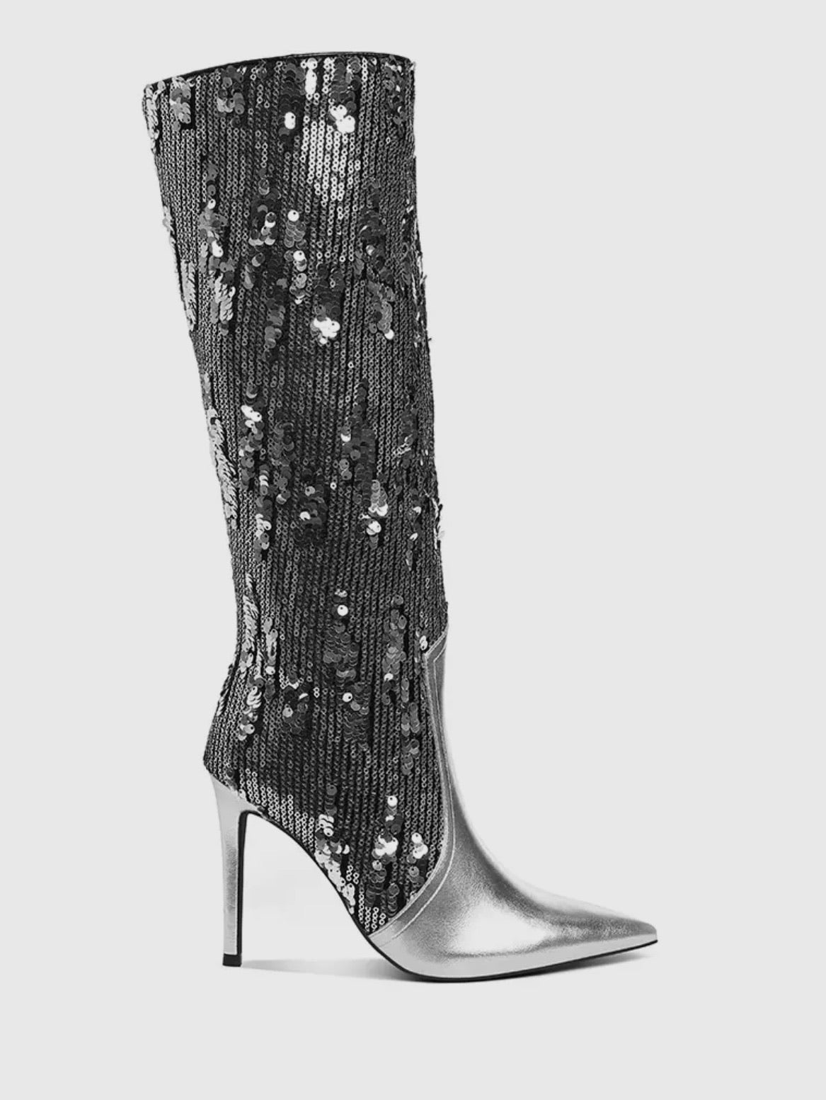 Step into the spotlight and leave ‘em guessing. Our Smoke & Mirrors Boots are made for bold entrances and unforgettable exits. Featuring a dazzling black sequin shaft paired with a sleek silver pointed toe and stiletto heel these boots bring serious drama with every step.

Metallic Faux Leather
Stiletto Heel
Sequin Embellishments
Side zip closure 
4” heel

SSB Underground Exclusive
This style is available for preorder through our SSB Underground collection. That means you’re getting early access to a limite
